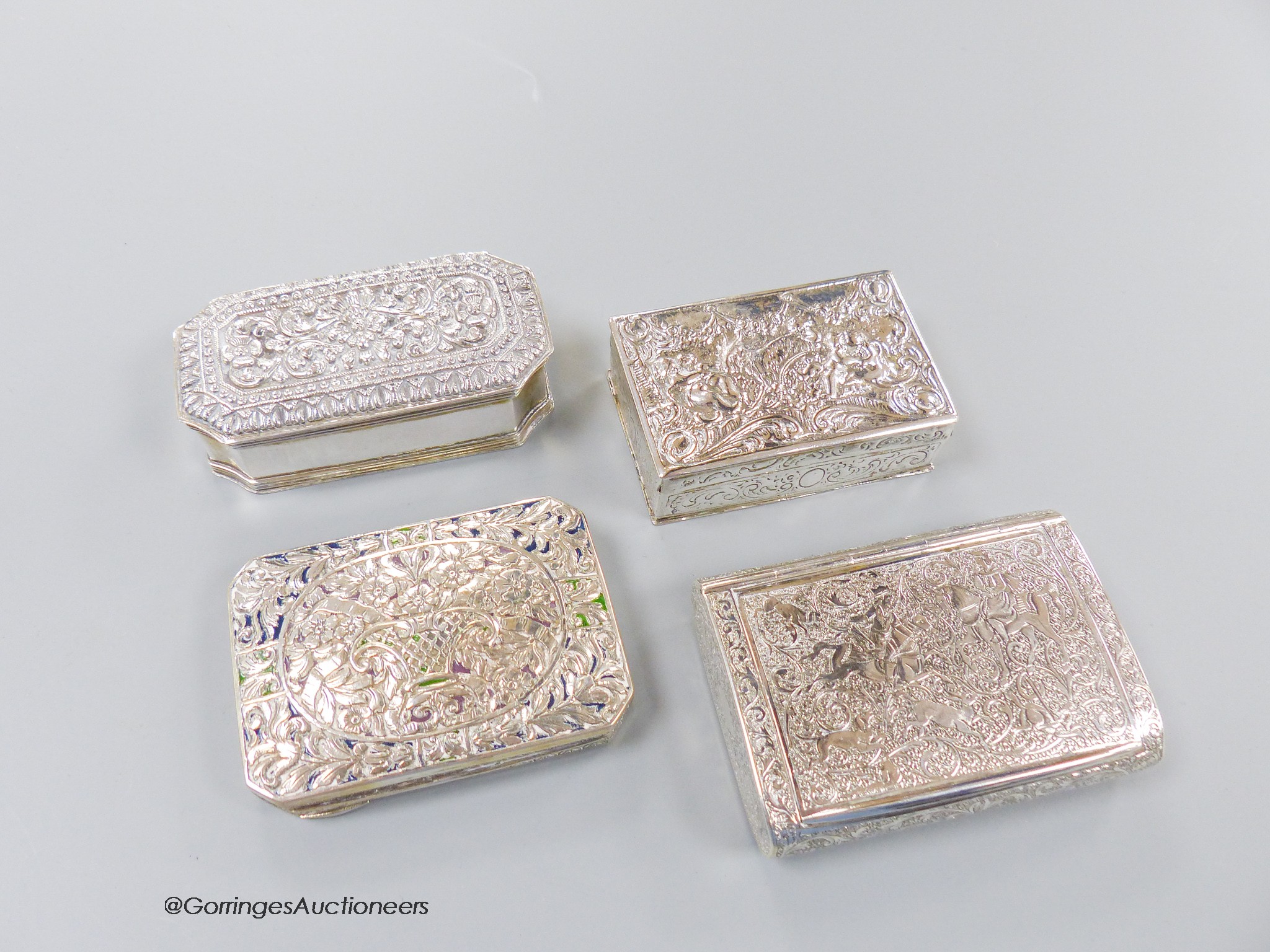 Four assorted 20th century continental white metal snuff boxes, including Middle Easter and one with plique a jour lid, largest 85mm, gross weight 11.6oz.